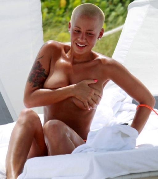 Amber Rose and her big boobs tanning topless outdoors