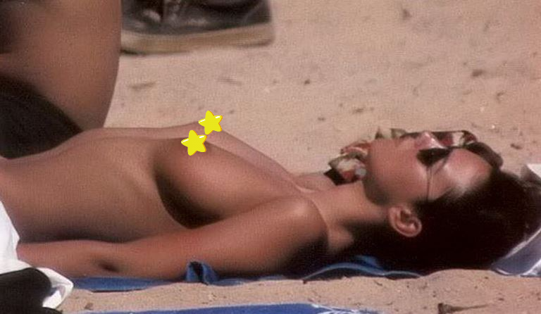 Italian actress Monica Bellucci tanning topless with her hot boobs at the beach