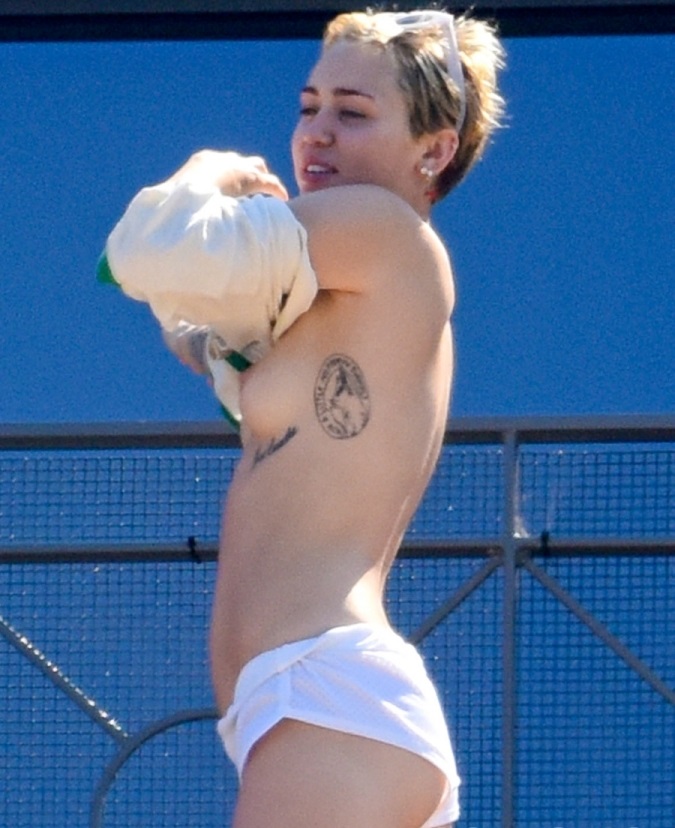 Miley Cyrus takes off shirt nude topless