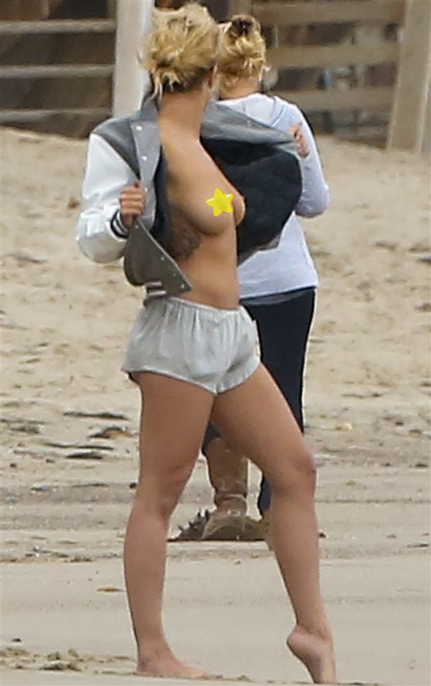 Rita Ora flashes her tits at the beach