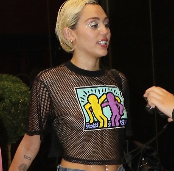 Miley Cyrus in see through mesh top - boobs exposed in public